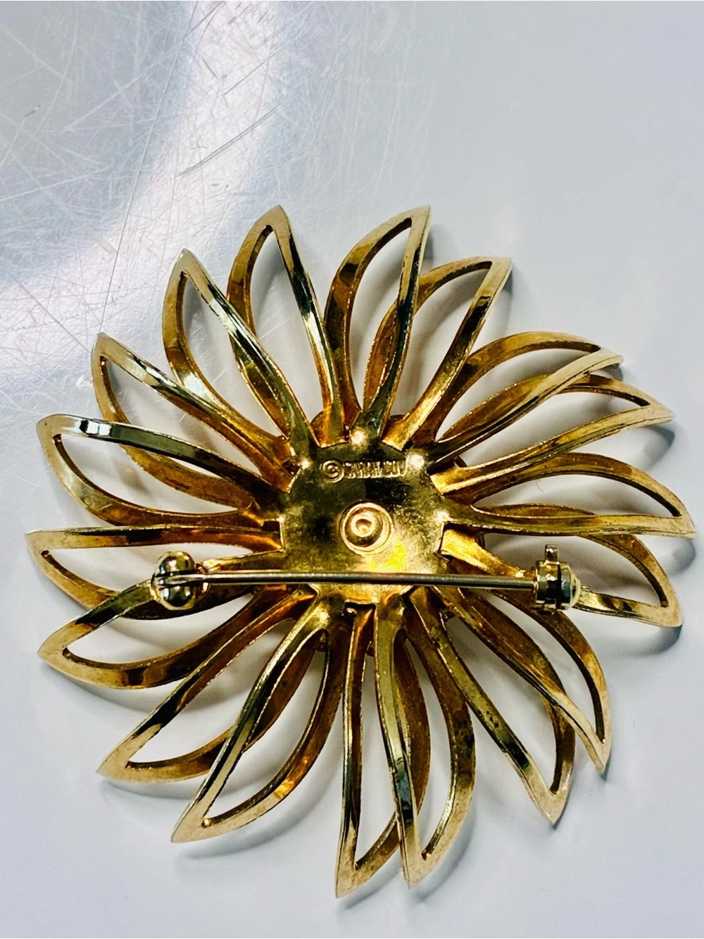 Sarah Coventry Gold-tone Sunburst Brooch with Deep Red Center